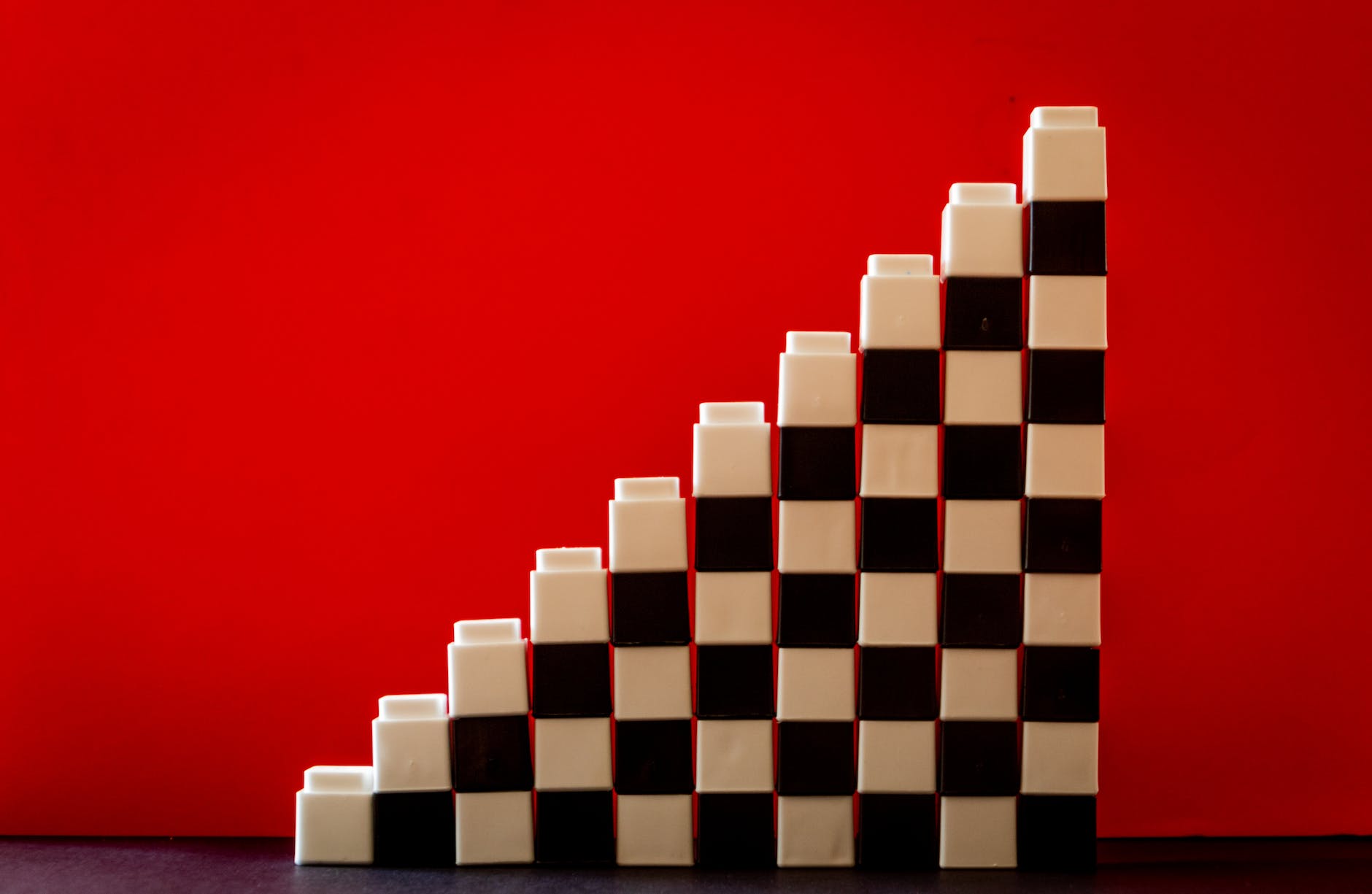 white and black checkered brick toys stacked on top of each other forming ladder